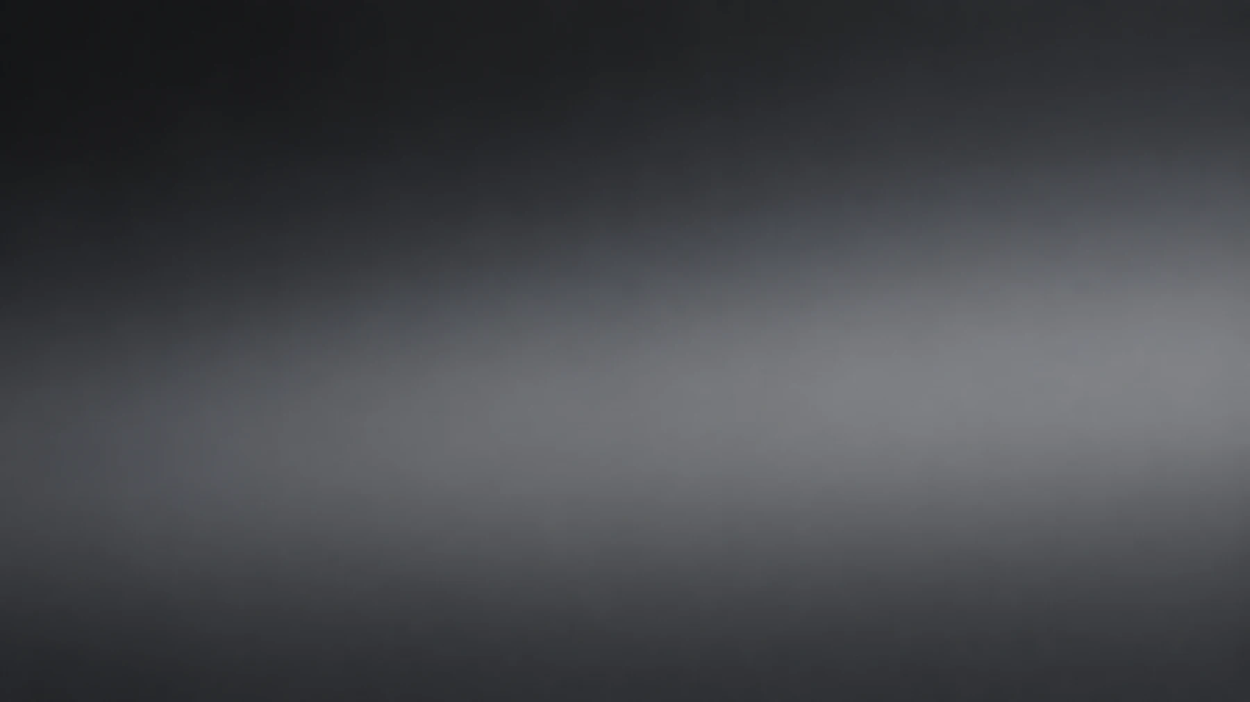 Soft, diffused silver-gray light flowing across a dark charcoal background.